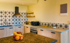 a kitchen with wooden cabinets and a counter top at Istron Agnanti in Agios Nikolaos