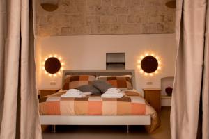 Postel nebo postele na pokoji v ubytování Pavì Trulli e Suites + 28 fotografií