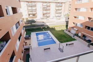 an overhead view of a courtyard with a swimming pool in a building at 2 Bedroom Apartment Lloret de Mar Terrace & Pool in Lloret de Mar