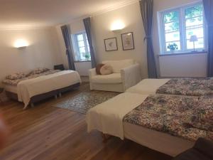 een hotelkamer met 2 bedden en een bank bij Apartment in Danmark- Agernaesgaard Otterup in Otterup