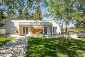 a modern house with a green yard at Apartmani Freedom place in Jagodina