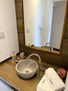 a bathroom with a sink and a large mirror at El Mirador in Salta