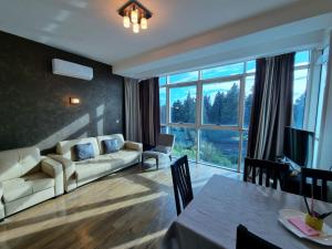 a living room with a couch and a table at Bečiči -Big apartments in Bečići