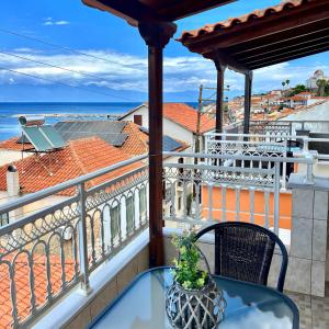 a balcony with a table and a view of the ocean at Sofotel in Koroni