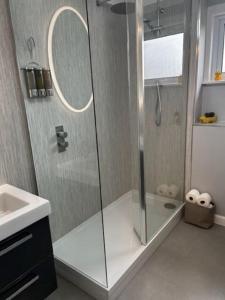 a bathroom with a glass shower with a sink at Dyce Flat - Near Airport in Dyce