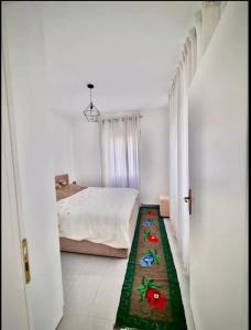 a bedroom with a bed and a green rug on the floor at Apartments Betti in Ulcinj