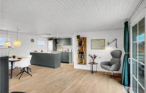 a kitchen and living room with a table and chairs at 2 Bedroom Stunning Home In Harboøre in Harboør