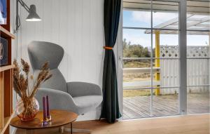 a living room with a chair and a table at 2 Bedroom Stunning Home In Harboøre in Harboør