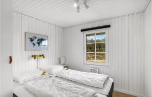 a white bedroom with a bed and a window at 2 Bedroom Stunning Home In Harbore in Harboør