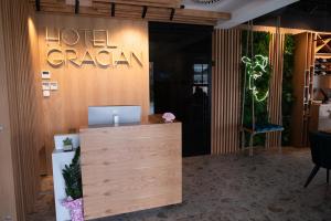 a hotel room with a reception desk and a hotel dream sign at HOTEL GRACIAN in Sremska Mitrovica