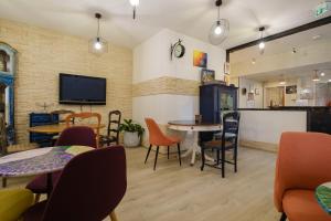 a restaurant with tables and chairs and a tv at Eqynox Hotel in Vitry-le-François
