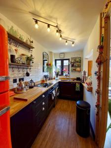 a large kitchen with a sink and a stove at Pass the Keys Oasis Escape Central Gorgeous in Poole