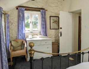 a bedroom with a bed and a dresser and a window at Millers Cottage, Broughton - family & pet friendly in Broughton in Furness