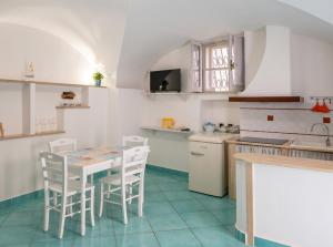 cocina con mesa y sillas en una habitación en Divina Casa Vacanze en Sperlonga