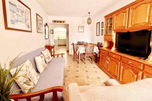 a living room with a couch and a flat screen tv at Vera Mar 8A Primera linea con Piscina y Parking in Arona