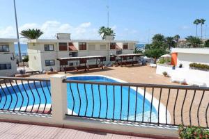 a swimming pool on a balcony of a building at Vera Mar 8A Primera linea con Piscina y Parking in Arona