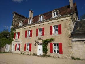 an old building with red shutters on it at Moulins de Clan in Jaunay-Clan