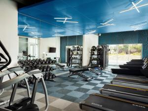 a gym with treadmills and machines in a room at Aloft Henderson in Las Vegas
