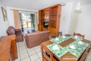 - une cuisine et une salle à manger avec une table et des chaises dans l'établissement Residencial Primavera, à Bombinhas