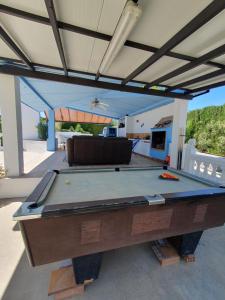 a pool table in the middle of a patio at Casa Olivar B&B in Tocon