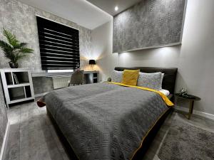 a bedroom with a large bed and a window at Leda Apartments in Budapest