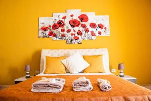 a bedroom with a bed with red flowers on it at Blu Mare Lampedusa Bed And Breakfast in Lampedusa