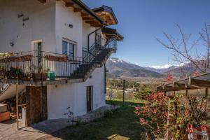 a house with balconies and a view of the mountains at Alle Coccinelle, Levico Terme Ospitar in Levico Terme