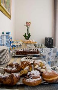 a table topped with lots of different types of donuts at Blu Mare Lampedusa Bed And Breakfast in Lampedusa