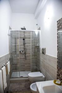 a bathroom with a shower and a toilet and a sink at Blu Mare Lampedusa Bed And Breakfast in Lampedusa +37 photos