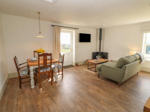 a living room with a table and a couch at Hudeway View in Barnard Castle