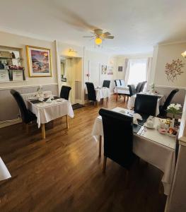 a restaurant with tables and chairs and a dining room at Crowndale Torquay - Exclusively for Adults in Torquay