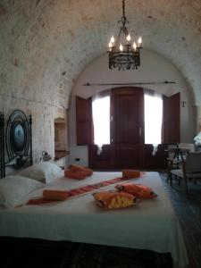 a bedroom with two beds and a chandelier at B&B Govinda Shanty House in Gorgofreddo