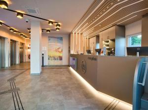 a lobby with a reception desk in a building at B&B Hotel Köln-City in Cologne