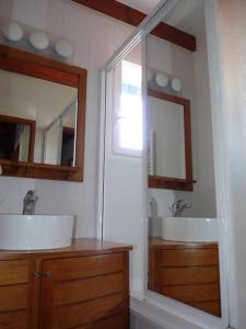 een badkamer met 2 wastafels en een grote spiegel bij Maison mitoyenne jardin piscine tennis in Hendaye