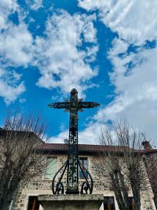 a cross on the side of a building at HL Hotel de la Loire in Goudet