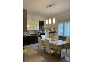 a kitchen and dining room with a table and chairs at Pierluigi's House in Cagliari