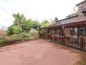 a house with a driveway next to a building at Acorns in Holywell