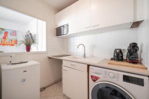 cocina con lavadora y fregadero en Appartement 4 pers à 50m de la plage, avec piscine, en Roquebrune-Cap-Martin