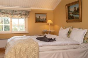 a bedroom with a large white bed with a window at Landhaus Kekkola in Mikkeli