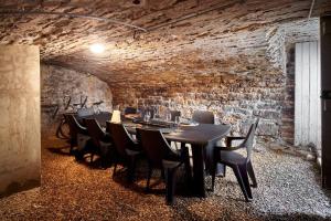 a dining room with tables and chairs and a brick wall at Le wine studio Gevrey-Chambertin in Gevrey-Chambertin