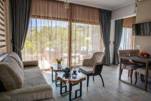 a living room with a couch and a table at Beach Walk Luxury Suites in Agios Nikolaos