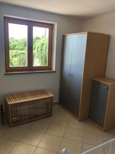 a room with a large cabinet and a window at Fig&Lavender Apartment in Šmarje
