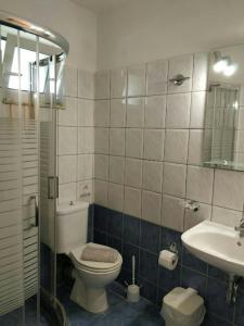 a bathroom with a toilet and a sink at Studio Thalassa in Kipseli