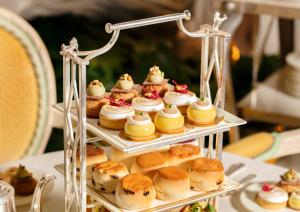 a display of pastries and donuts on a table at The Ritz London in London