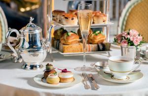 a table with plates of pastries and a cup of coffee at The Ritz London in London