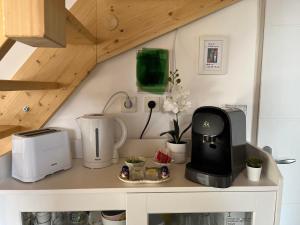 a kitchen counter with a coffee maker and a toaster at Petit Fare Rochois avec mezzanine in La Roche-des-Arnauds