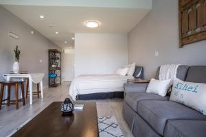 a living room with a couch and a bed at Kihei Bay Surf 227 in Kihei