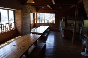 une chambre avec deux bancs en bois dans une chambre avec fenêtres dans l'établissement Dogashima Land Hohia / Vacation STAY 81112, à Tago