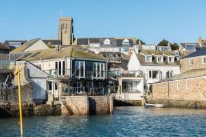 a group of buildings on the water next to a city at 2 Clifton Place in Salcombe