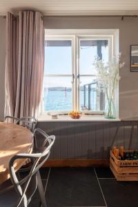 a dining room with a table and a window at 2 Clifton Place in Salcombe
